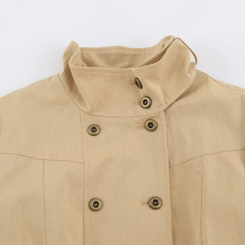 Elegant Double-breasted Coat Featuring A Stand-up Collar, Pockets, And A Fitted Waist